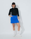 Person wearing a black top and blue skirt on a white background