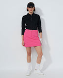 Person wearing a black top and pink skirt on a white background