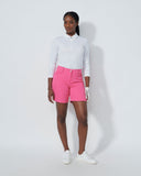 Person wearing a white shirt and pink shorts on a white background