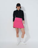 Person wearing a black top and pink skirt on a white background