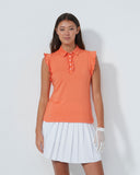 Woman wearing an orange top and white skirt on a plain background