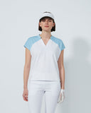 Woman wearing a white and light blue golf outfit on a plain background
