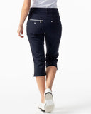 Person wearing navy blue capri pants on a white background