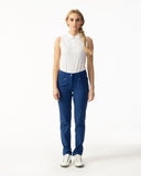 Woman wearing a white sleeveless top and blue pants on a white background