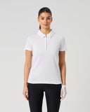 A woman modeling a short-sleeve collared polo shirt with a red and white gingham check pattern, paired with black pants and a white glove, against a light gray studio background.