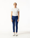 Woman wearing a white polo shirt and blue pants on a white background