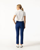 Woman wearing a white polo shirt and blue pants on a white background