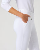 White fitted riding breeches with a zippered fly and side pocket, shown on a model from the waist down against a light gray studio background.