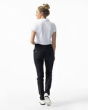 Woman wearing a white polo shirt and black pants on a white background