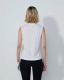 Person wearing a white sleeveless top and black pants on a plain background