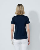 Person wearing a navy blue t-shirt and white pants on a plain background