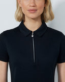 Person wearing a black polo shirt with a zipper on a plain background