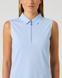 A woman wearing a light blue sleeveless polo-style top with a short front zipper and collar, shown against a plain light gray studio background.
