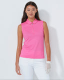 Woman wearing a pink sleeveless polo shirt and white pants on a white background