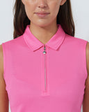 Close-up of a person wearing a pink sleeveless polo shirt with a zipper.
