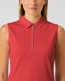 A woman wearing a sleeveless red polo-style top with a short front zipper, shown from the shoulders to the waist against a light gray studio background.