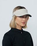 Woman wearing a beige visor against a plain background
