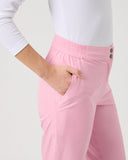 Person wearing a white top and pink pants on a plain background