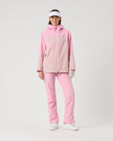 Person wearing a pink polka dot jacket and pants on a white background