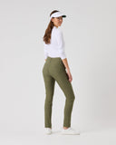 Woman wearing a white shirt, green pants, and a visor on a light gray background