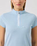 Light blue short-sleeve top with a quarter zip on a plain background