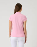 Person wearing a pink polo shirt and white pants on a light gray background