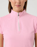 Person wearing a pink short-sleeve top with a quarter zip on a light gray background