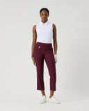 Person wearing a white sleeveless shirt and maroon pants on a white background