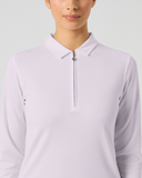 A woman wearing a light lavender long-sleeve quarter-zip polo shirt against a plain light gray studio background.