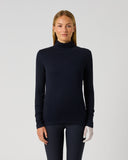 A woman modeling a dark navy ribbed mock neck sweater against a light gray studio background.
