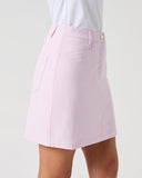A light pink A-line mini skirt with a button closure and side pockets, shown on a model wearing a white top against a light gray background.