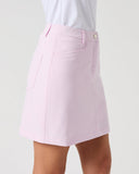 A light pink A-line mini skirt with a button closure and side pockets, shown on a model wearing a white top against a light gray background.