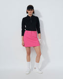 Person wearing a black top and pink skirt on a white background