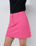 Person wearing a black top and pink skirt on a plain background
