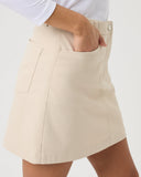 Beige skirt worn by a person on a white background