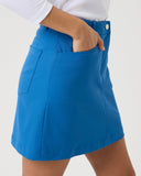 Blue skirt worn by a person on a white background