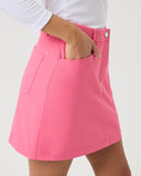 Person wearing a pink skirt with a white background