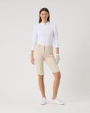 Person wearing a white shirt and beige shorts on a light gray background