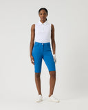 Person wearing a white polo shirt and blue shorts on a white background