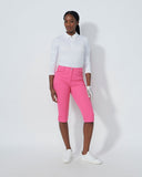Person wearing a white shirt and pink pants on a white background