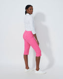 Person wearing a white long-sleeve shirt and pink pants on a white background
