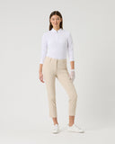 Woman wearing a white shirt and beige pants on a white background
