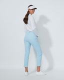Woman wearing a white shirt and light blue pants on a white background