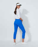 Woman wearing a white shirt, blue pants, and a visor on a white background