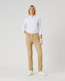 A woman modeling a white long-sleeve polo shirt and beige slim-fit trousers, standing against a light gray studio background.