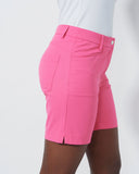 Pink shorts worn by a person on a white background