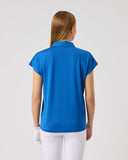 Person wearing a blue polo shirt and white pants on a light gray background