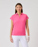 Woman wearing a pink polo shirt and white pants on a gray background
