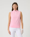 Woman wearing a pink sleeveless top and white pants on a light gray background