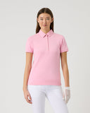 Person wearing a pink polo shirt and white pants on a light gray background